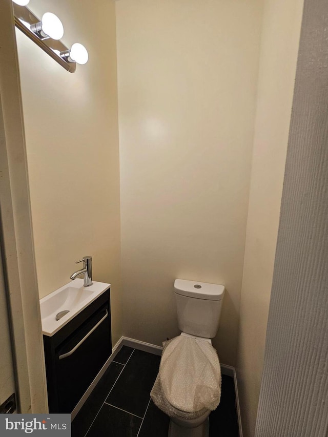 bathroom with tile patterned floors, vanity, and toilet