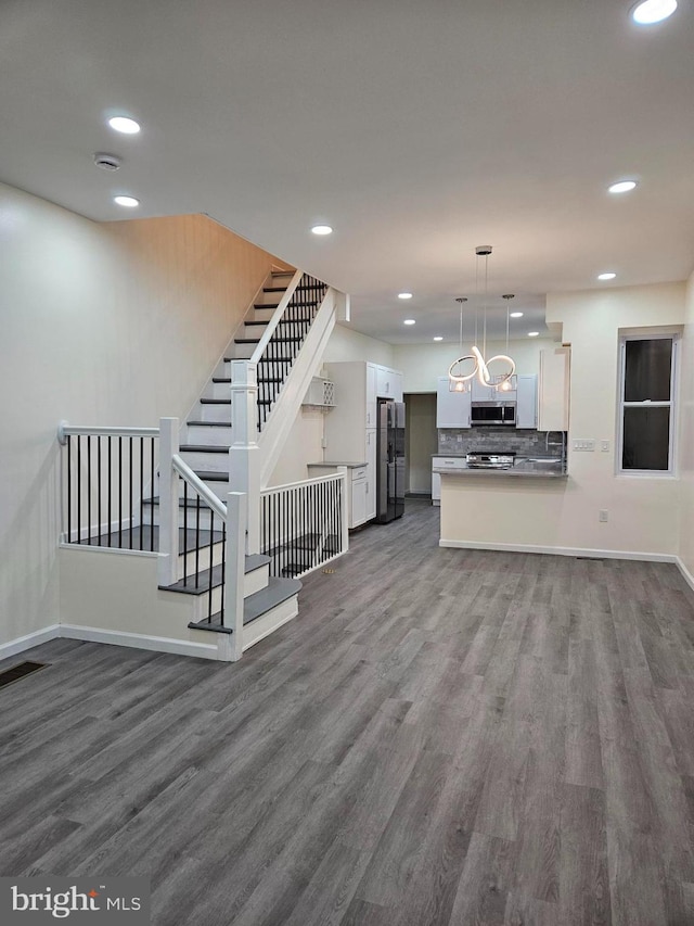 unfurnished living room featuring dark wood-type flooring