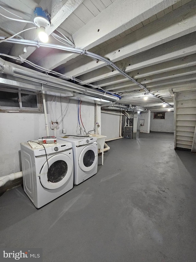 laundry area with washing machine and dryer and sink