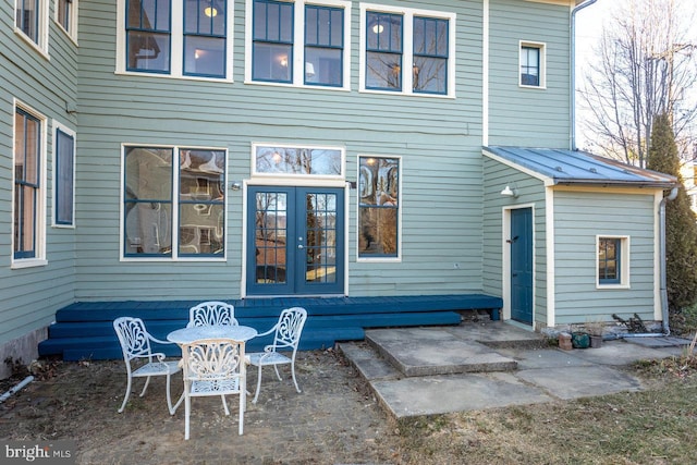 rear view of property featuring a patio area and french doors