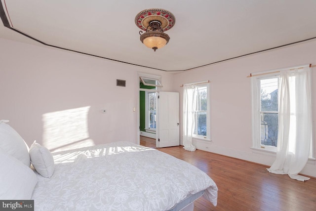 bedroom with hardwood / wood-style floors