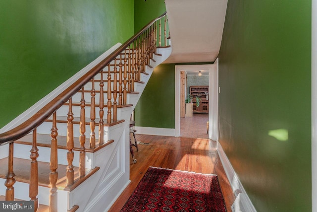 staircase featuring wood-type flooring