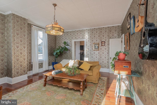 living room with wood-type flooring and crown molding