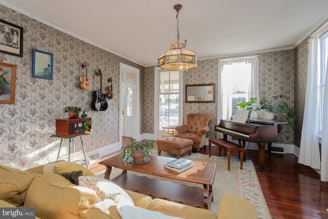 living room with dark hardwood / wood-style flooring and crown molding