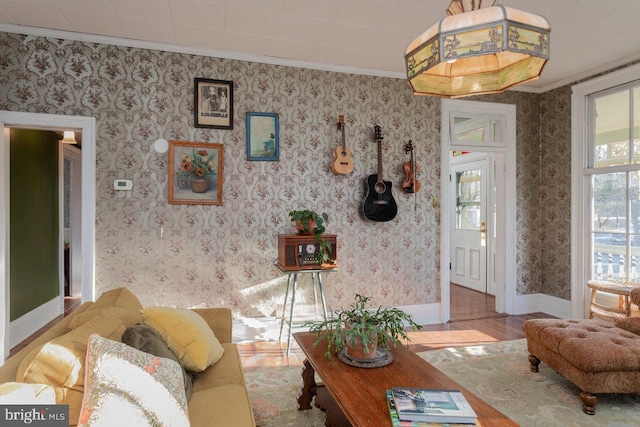 living room with light hardwood / wood-style floors and crown molding