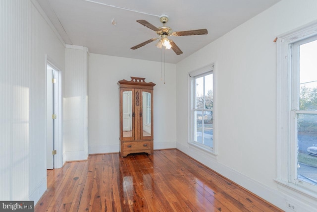 spare room with hardwood / wood-style floors and ceiling fan