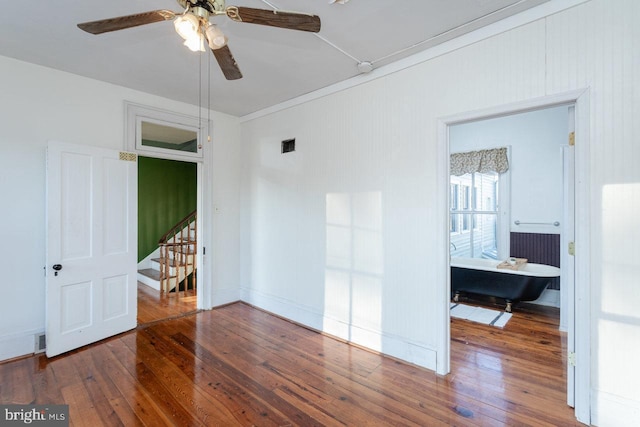 spare room with wood-type flooring and ceiling fan