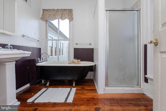 bathroom with shower with separate bathtub and hardwood / wood-style flooring