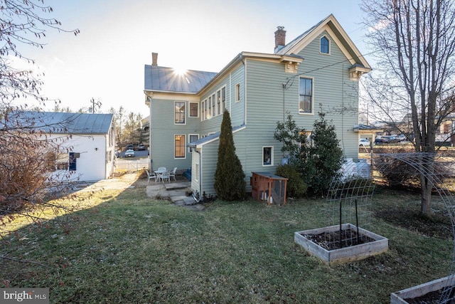 rear view of property featuring a yard