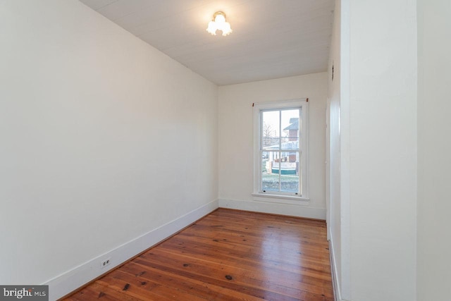 unfurnished room with dark hardwood / wood-style floors