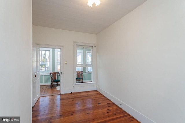 empty room with dark hardwood / wood-style flooring