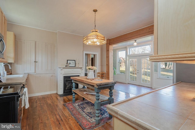 dining area featuring hardwood / wood-style floors, french doors, and sink