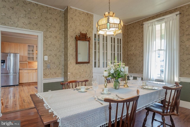 dining space featuring a chandelier, hardwood / wood-style floors, and ornamental molding