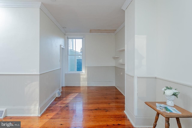 hall featuring hardwood / wood-style floors and ornamental molding