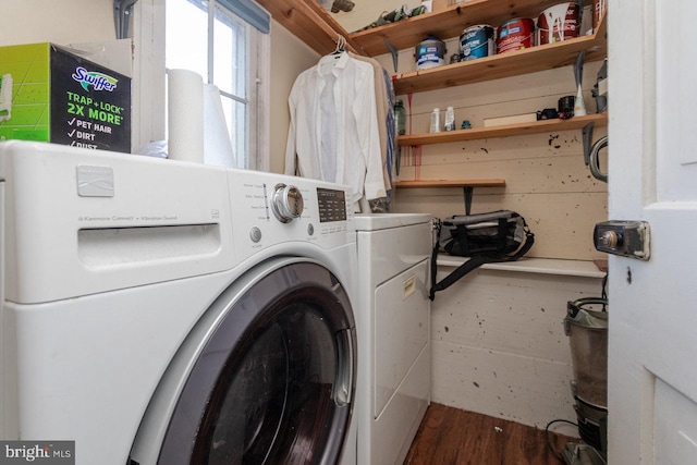 clothes washing area featuring washer and clothes dryer and hardwood / wood-style floors