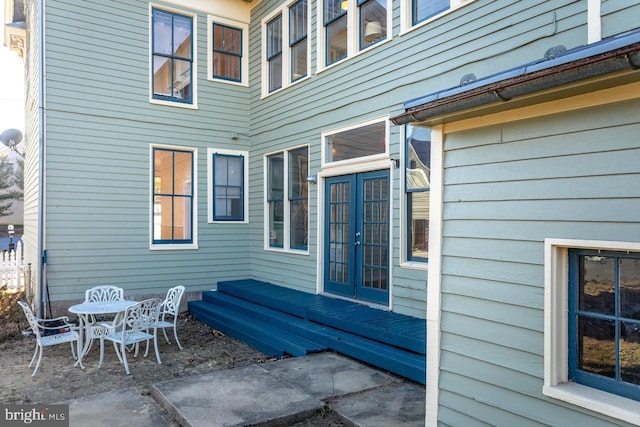 view of patio / terrace featuring a wooden deck and french doors