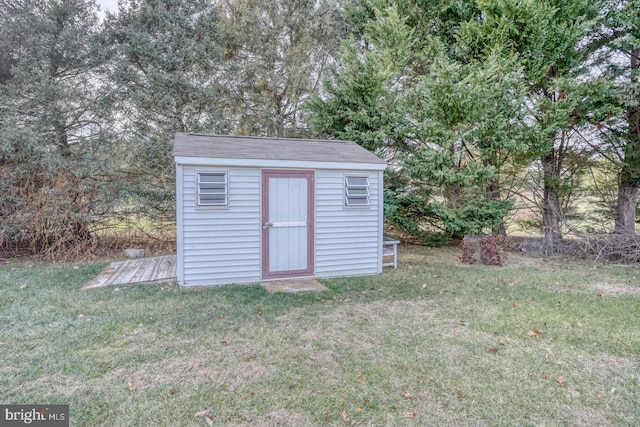 view of outbuilding featuring a yard