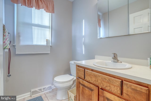 bathroom featuring vanity, tile patterned floors, and toilet