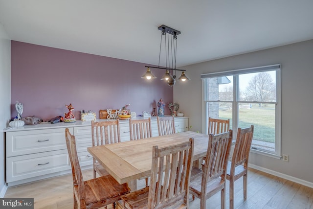 dining space with light wood-type flooring