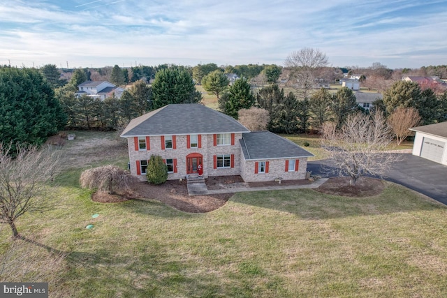 view of front of property with a garage and a front lawn