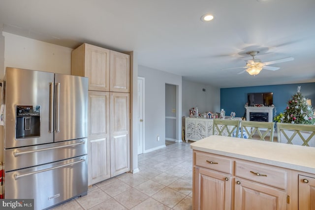 kitchen with light brown cabinetry, stainless steel fridge with ice dispenser, ceiling fan, and light tile patterned flooring