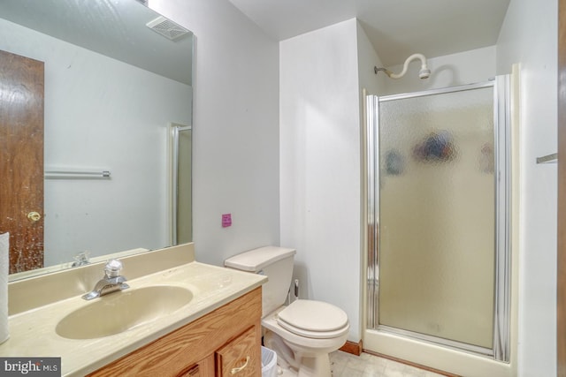 bathroom with an enclosed shower, vanity, and toilet