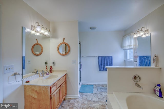 bathroom with vanity and a washtub