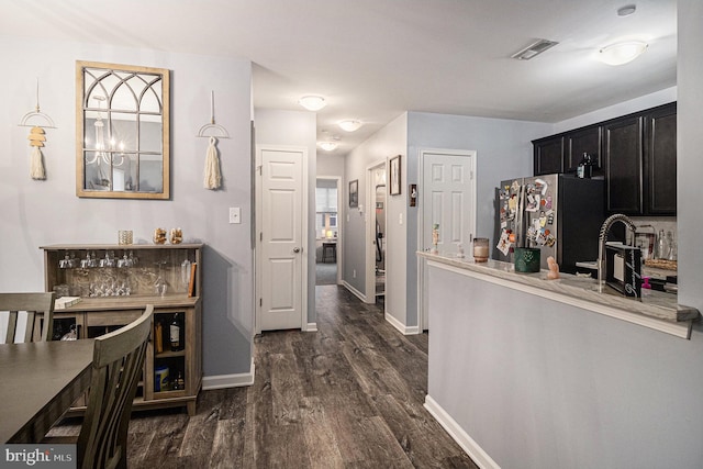 kitchen featuring stainless steel fridge, dark hardwood / wood-style floors, and sink