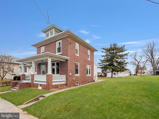 view of home's exterior with covered porch and a lawn