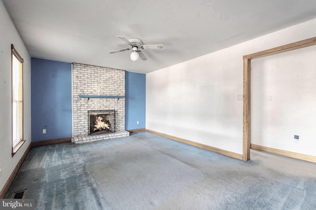 unfurnished living room featuring a fireplace, carpet floors, and ceiling fan