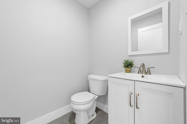 bathroom featuring vanity, toilet, and wood-type flooring