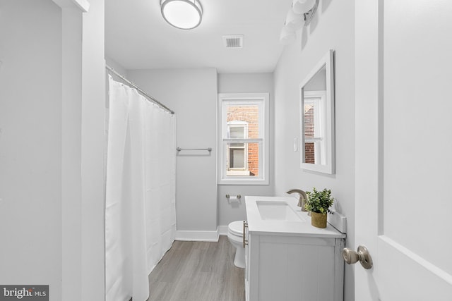 bathroom with vanity, hardwood / wood-style flooring, and toilet