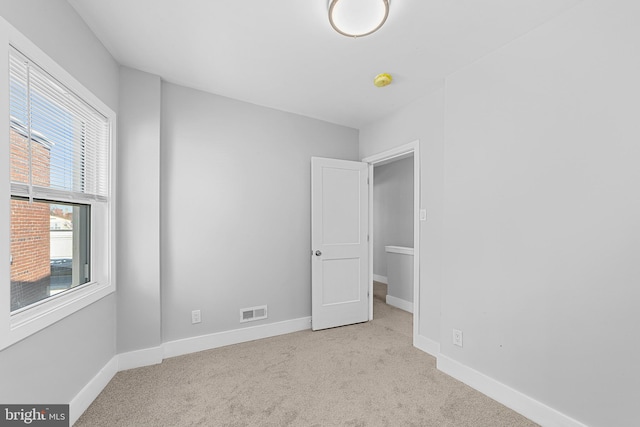 unfurnished bedroom featuring light colored carpet