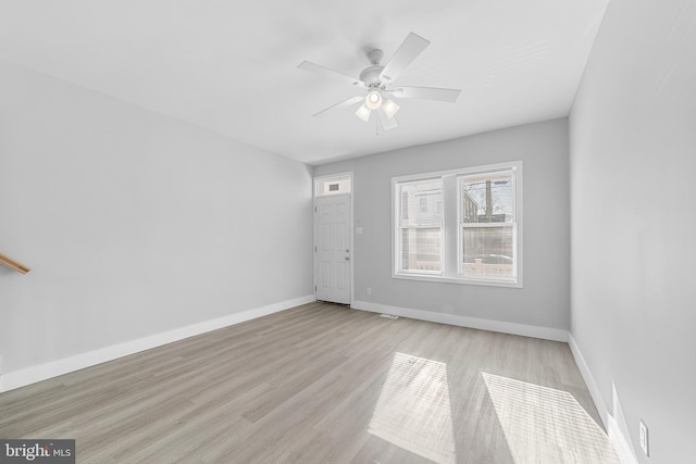 spare room with light hardwood / wood-style floors and ceiling fan