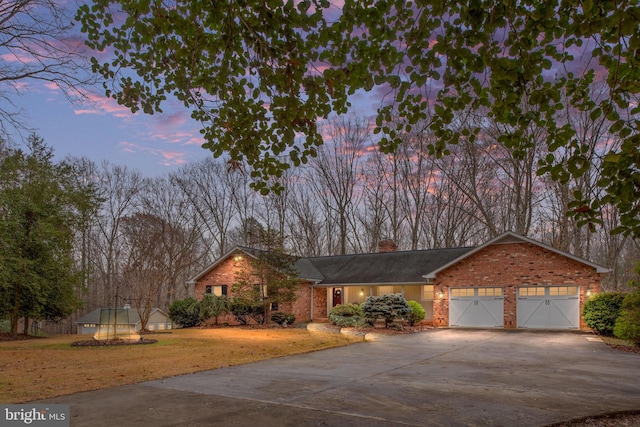 view of front of home featuring a yard, a trampoline, and a garage