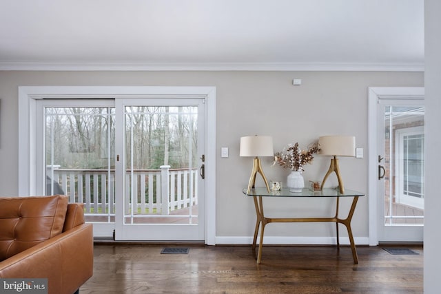 doorway with dark hardwood / wood-style floors and crown molding