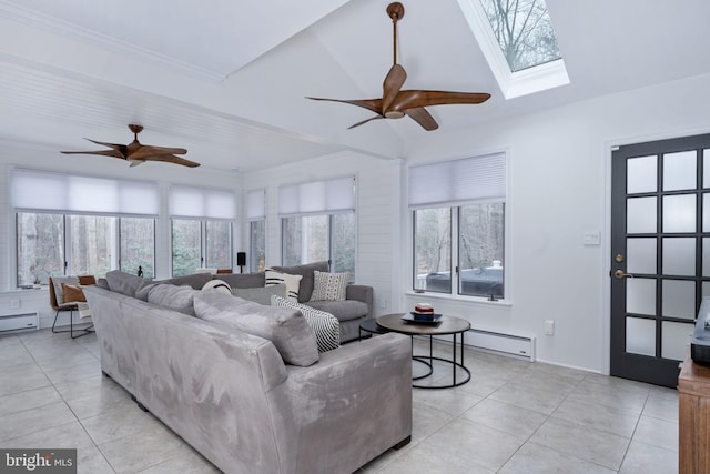 tiled living room with plenty of natural light, lofted ceiling with skylight, and a baseboard heating unit