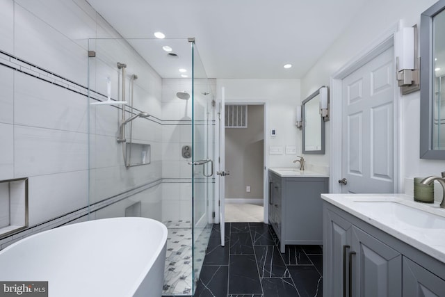 bathroom featuring vanity and shower with separate bathtub