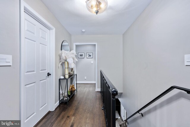 corridor with dark hardwood / wood-style flooring