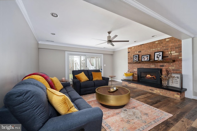 living room with a fireplace, wood-type flooring, and crown molding