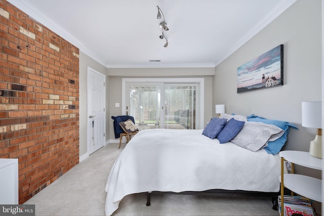 bedroom featuring light carpet, crown molding, and track lighting