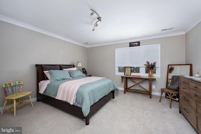 carpeted bedroom with track lighting and ornamental molding