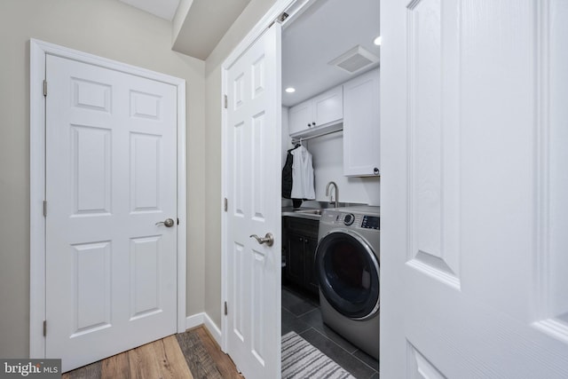 laundry area featuring washer / clothes dryer, sink, cabinets, and dark hardwood / wood-style floors