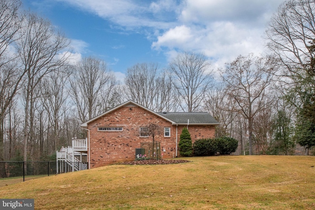 view of side of property with a yard and central AC unit