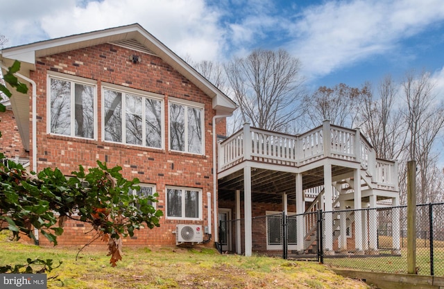 rear view of house featuring ac unit and a wooden deck