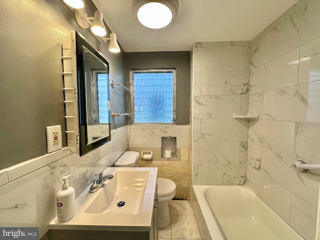 bathroom with tile walls, toilet, and vanity