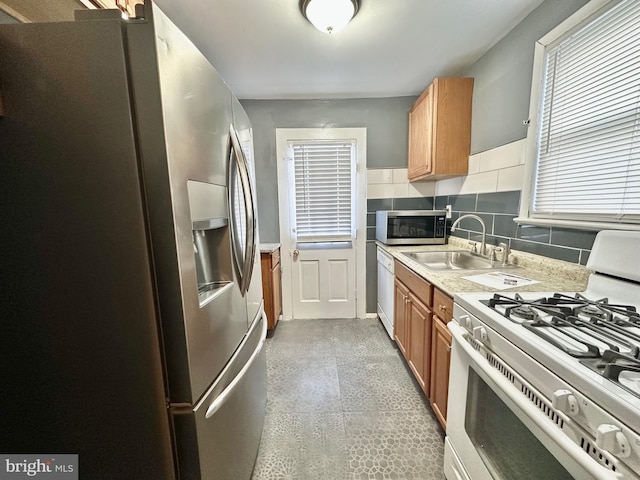 kitchen featuring sink, stainless steel appliances, and backsplash