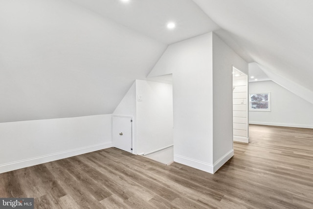 bonus room featuring lofted ceiling and hardwood / wood-style floors