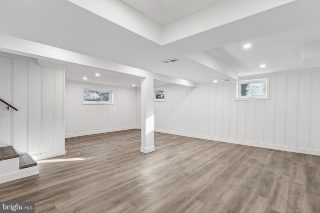 basement with hardwood / wood-style flooring