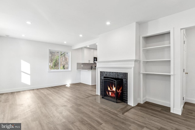 unfurnished living room featuring hardwood / wood-style flooring